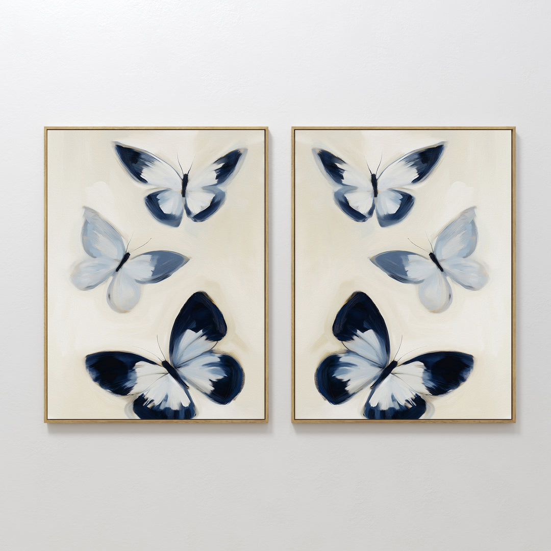 The Midnight Wings Set of 2 features framed wall art with abstract blue and white butterflies on light beige backgrounds, making stylish modern decor to elevate any room.
