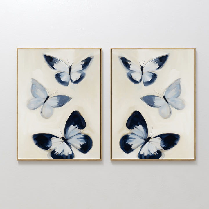 The Midnight Wings Set of 2 features framed wall art with abstract blue and white butterflies on light beige backgrounds, making stylish modern decor to elevate any room.