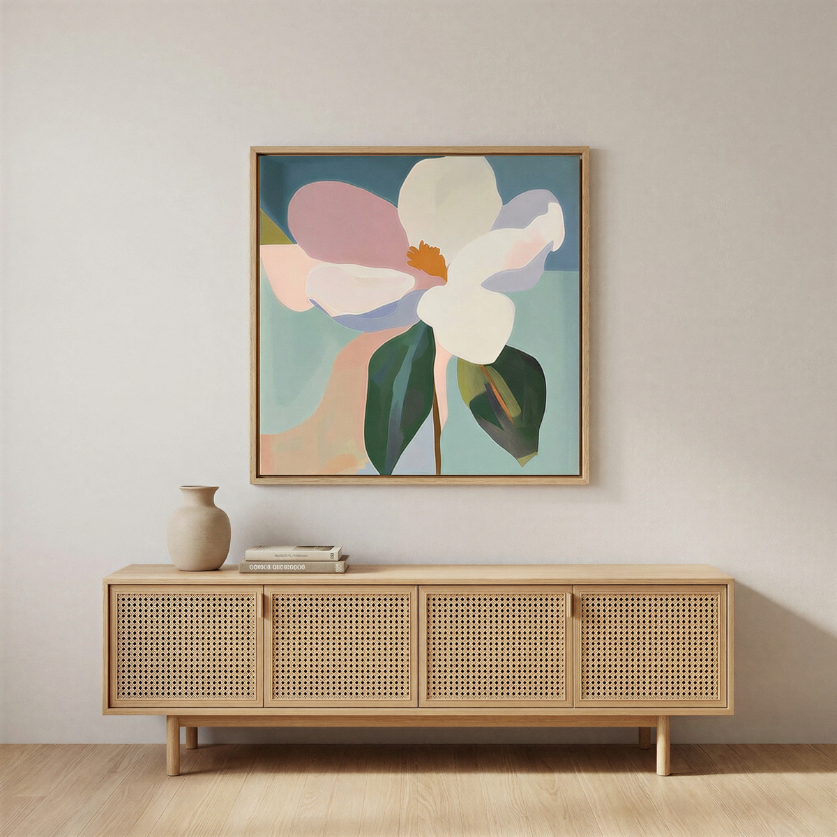 A minimalist room featuring a rattan sideboard with books and a ceramic vase, highlighted by modern elegance from the Bold Bloom Canvas Art, a large, colorful floral wall art set against a plain light wall.