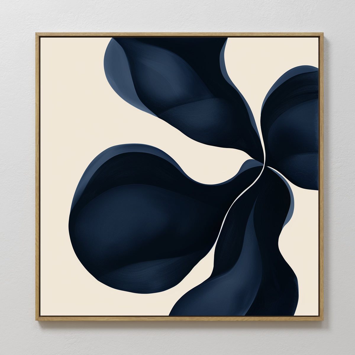 Blossom Blue Abstract Canvas Art in a gold frame showcases four dark blue organic shapes swirling on a beige background, creating a fluid, petal-like effect—ideal minimalist wall art for enhancing any white wall.