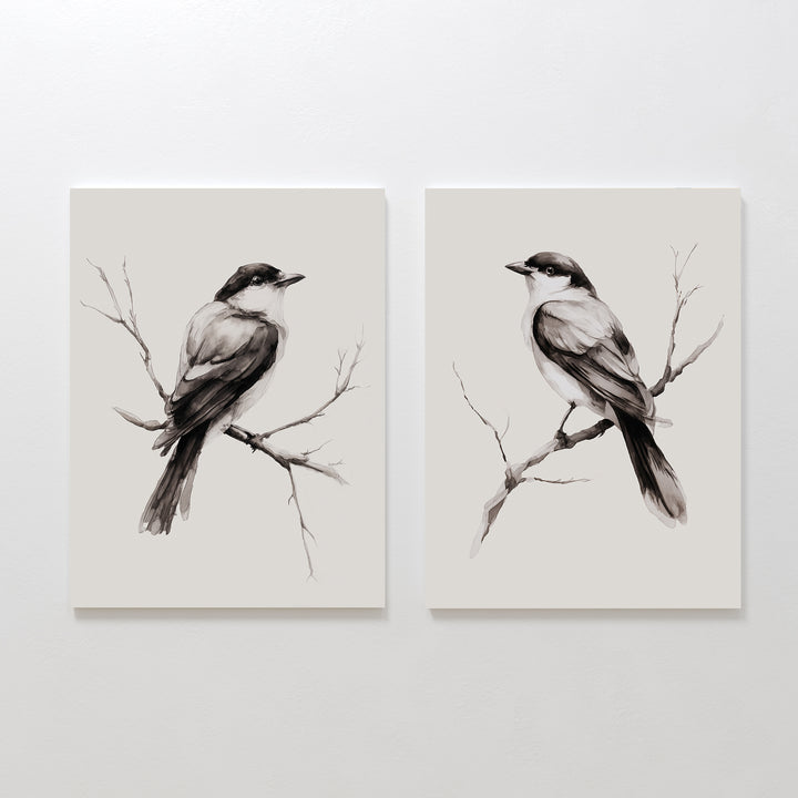 The Still Perch Set of 2 features minimalist black and white bird prints, each perched on a branch and facing opposite ways on a light backdrop. This neutral-toned wall art brings a touch of Nordic Park style to any space.