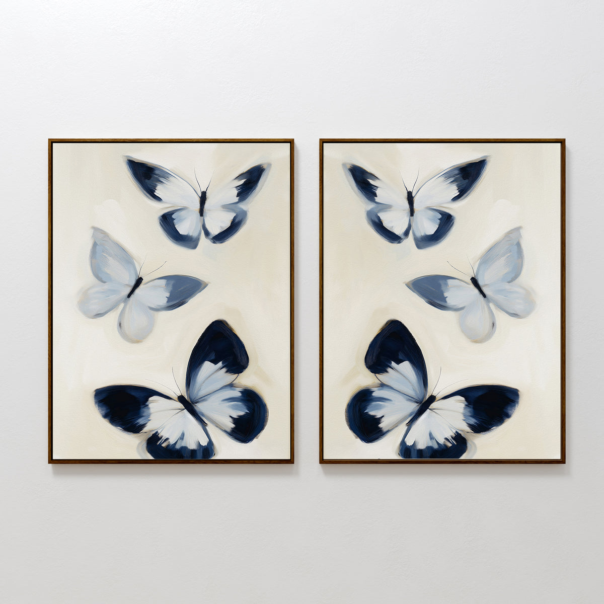 The Midnight Wings Set of 2 features framed wall art with blue and white butterflies and dark accents, hung side by side on a white wall for modern, Nordic Park-inspired decor.