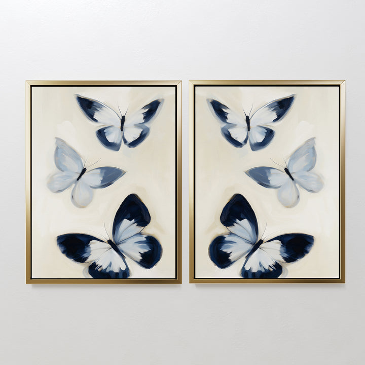 The Midnight Wings Set of 2 features framed paintings of abstract blue, black, and white butterflies on a light background—ideal as modern wall decor or striking butterfly art for your space.