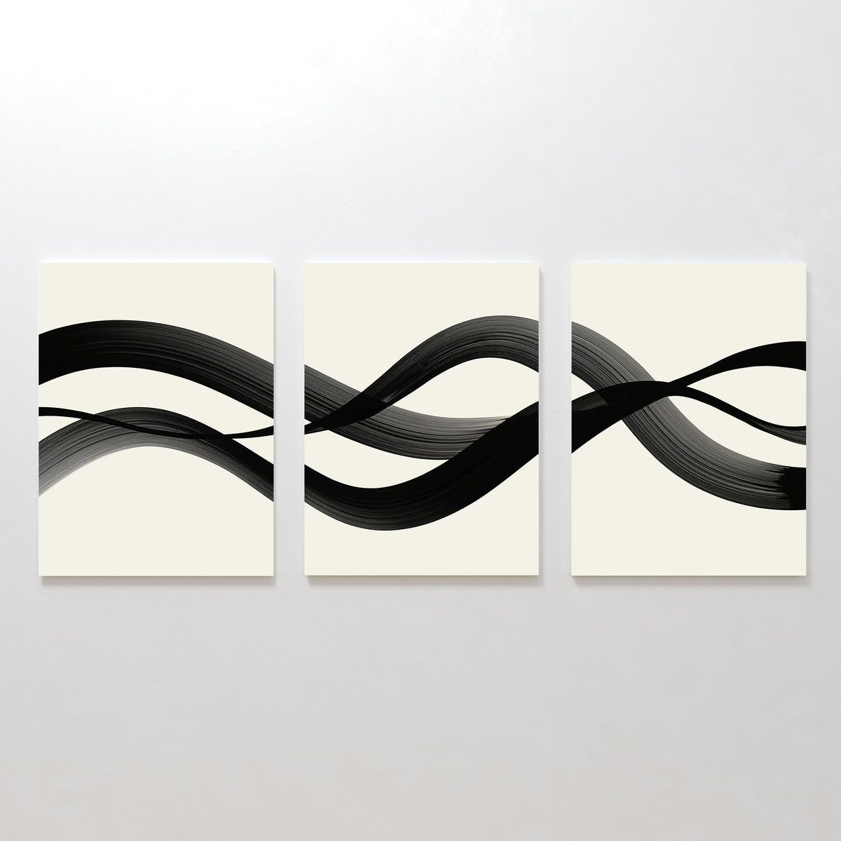 The Fluid Curves Set of 3 features minimalist canvases with continuous black brushstrokes on light backgrounds, creating a serene, abstract wall art trio with wave-like Nordic-inspired patterns.