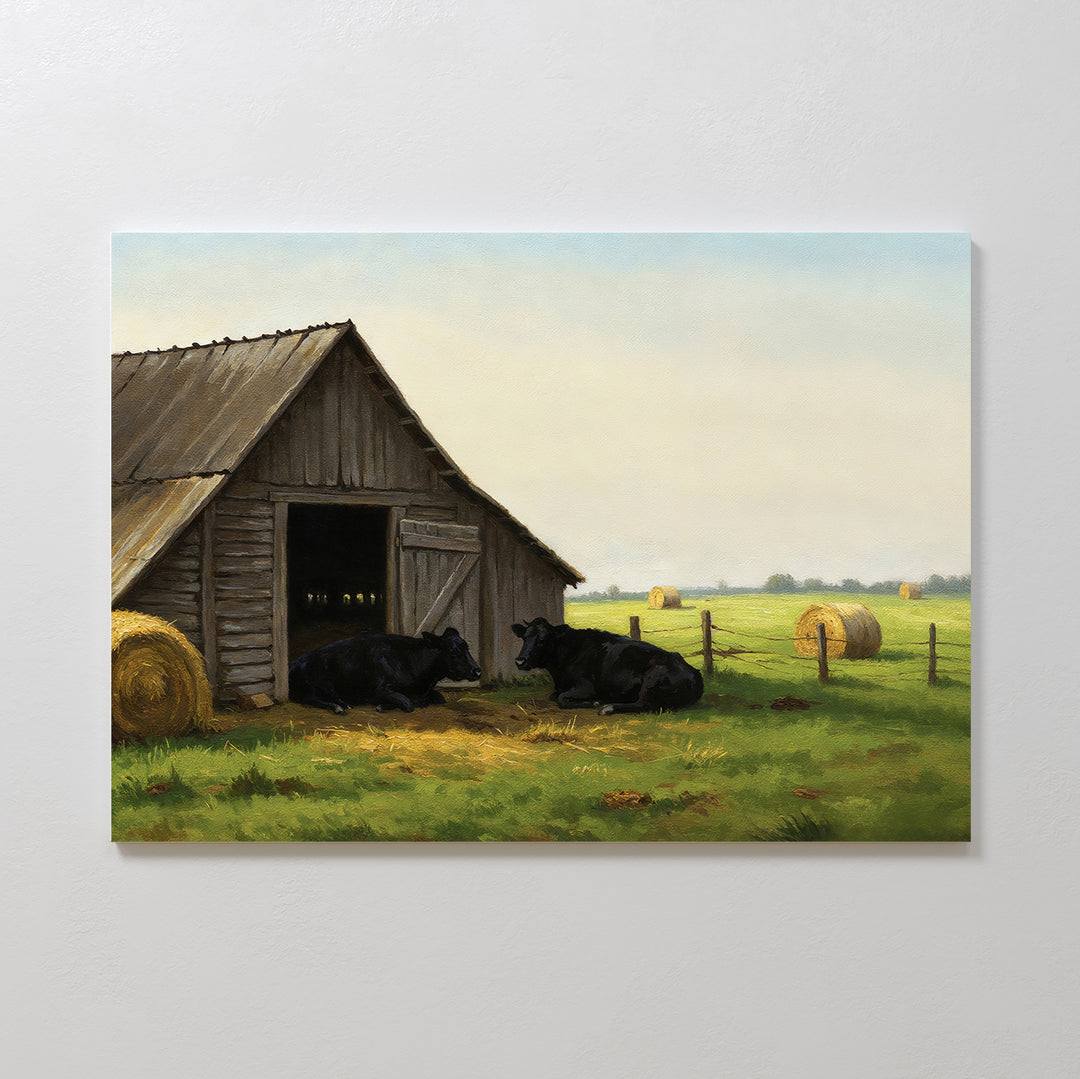 Barnside Rest Canvas Art features two black cows resting beside a wooden barn in a grassy field, making it the perfect rustic wall decor to bring charm and warmth to your cozy living room.