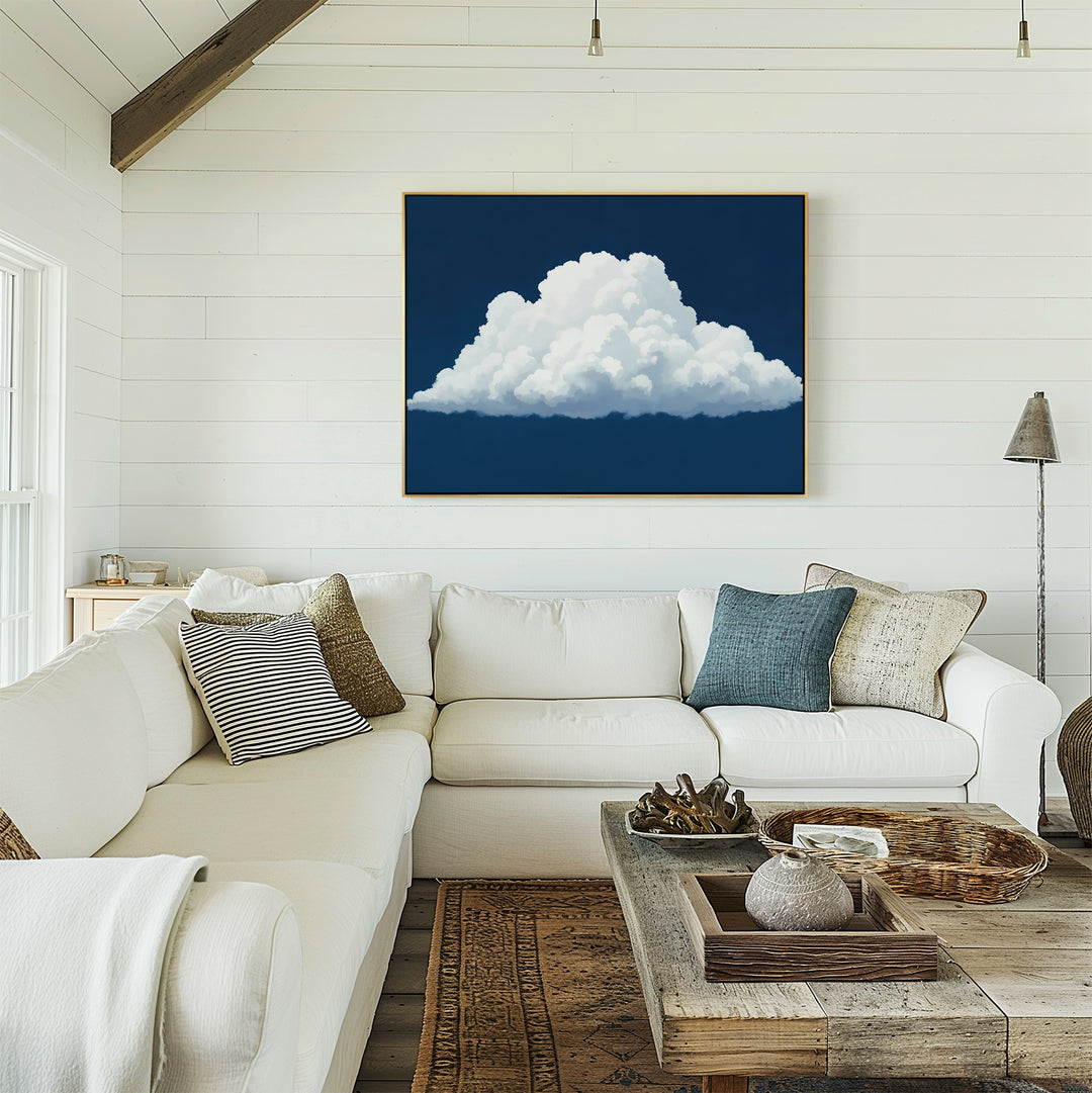 A bright living room features a white sectional sofa, rustic wood coffee table, and Blue Horizon Cloud Canvas Art as minimalist wall art on a shiplap wall. Cozy pillows and decor add comfort to this modern space.