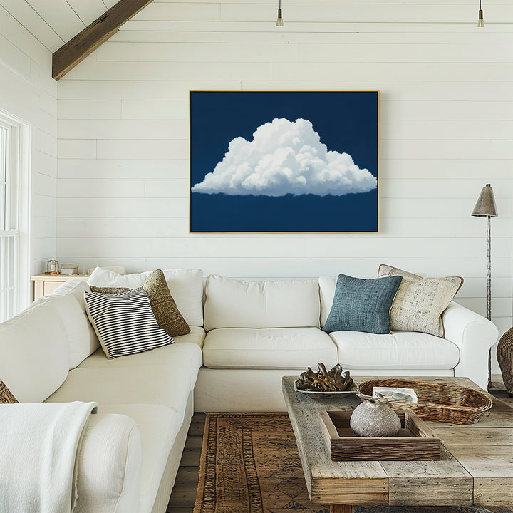 A bright living room features a white sectional sofa, rustic wood coffee table, and Blue Horizon Cloud Canvas Art as minimalist wall art on a shiplap wall. Cozy pillows and decor add comfort to this modern space.