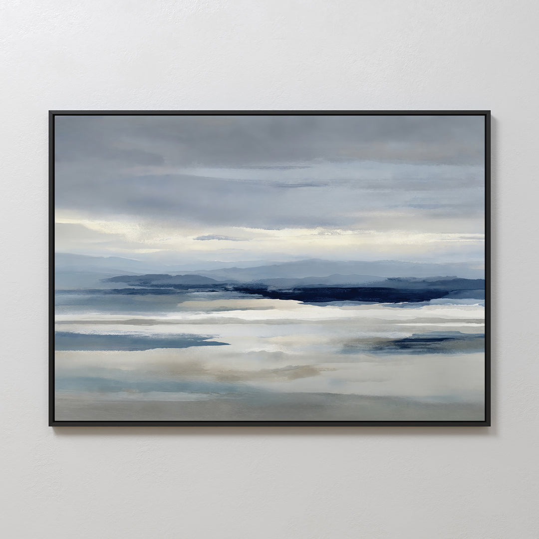 Blue Mist Horizon Canvas Art: a framed canvas featuring serene blues and grays with calm water, distant mountains, and a cloudy sky—ideal minimalist wall art for tranquil living room decor.