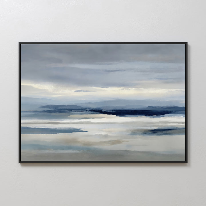 Blue Mist Horizon Canvas Art: a framed canvas featuring serene blues and grays with calm water, distant mountains, and a cloudy sky—ideal minimalist wall art for tranquil living room decor.