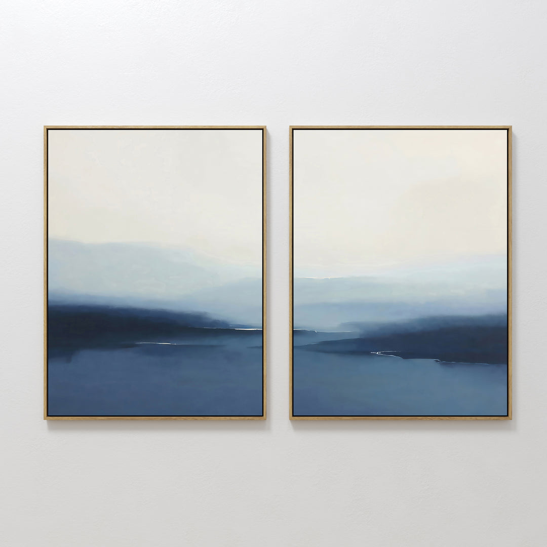 The Blue Valley Mist Set of 2 features framed abstract paintings with soft blue and white gradients, evoking misty horizons. Ideal as minimalist wall art decor, these prints add a serene touch to any room.