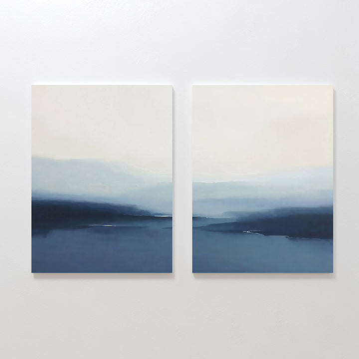 The Blue Valley Mist Set of 2 features square abstract prints with misty blue and white landscapes, soft lines evoking distant mountains and water under a pale sky—ideal minimalist wall art for any space.
