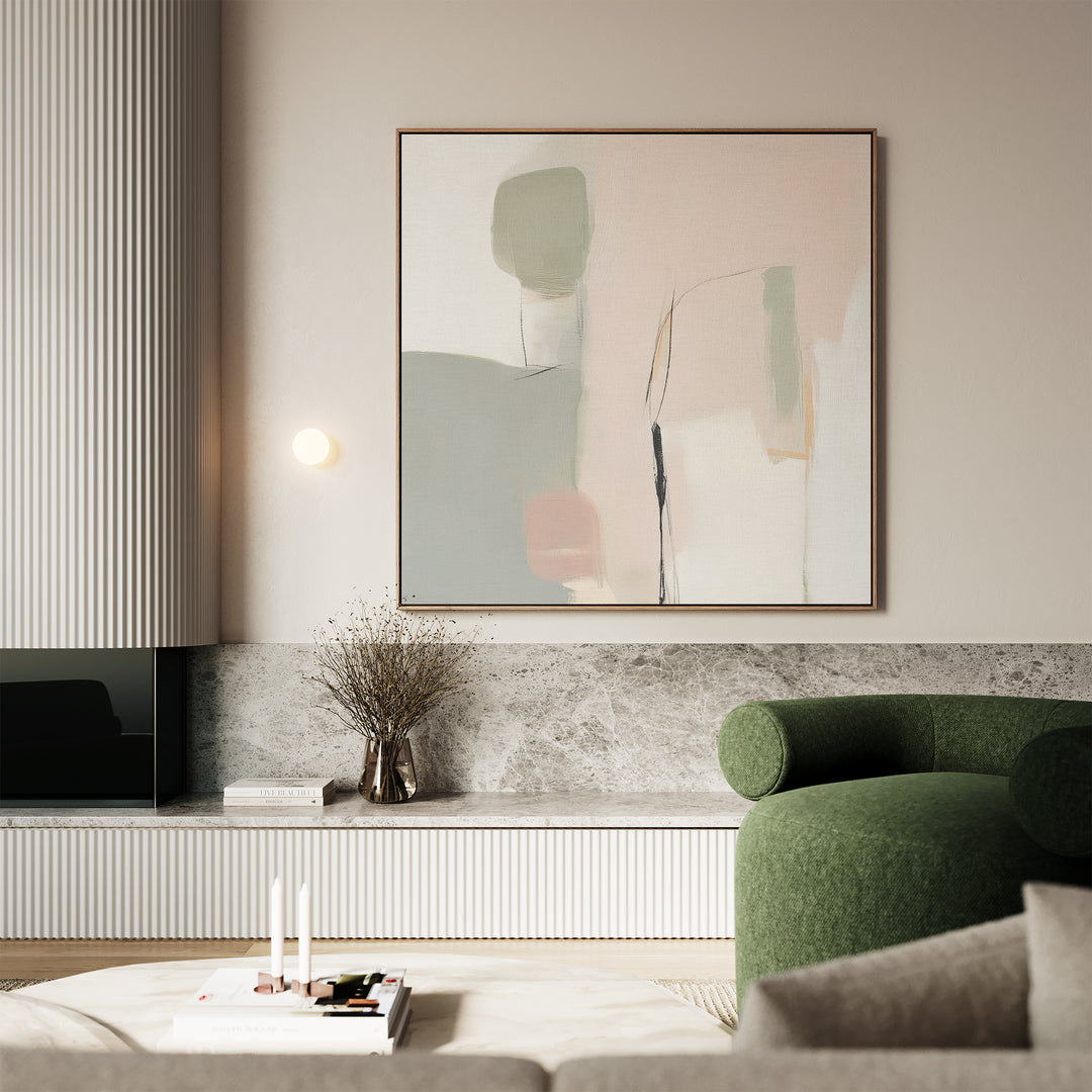 A modern living room featuring a green armchair, Blushed Horizon Canvas Art, a marble shelf with dried branches, books, and candles. Neutral tones and soft lighting create a calm, minimalist vibe.