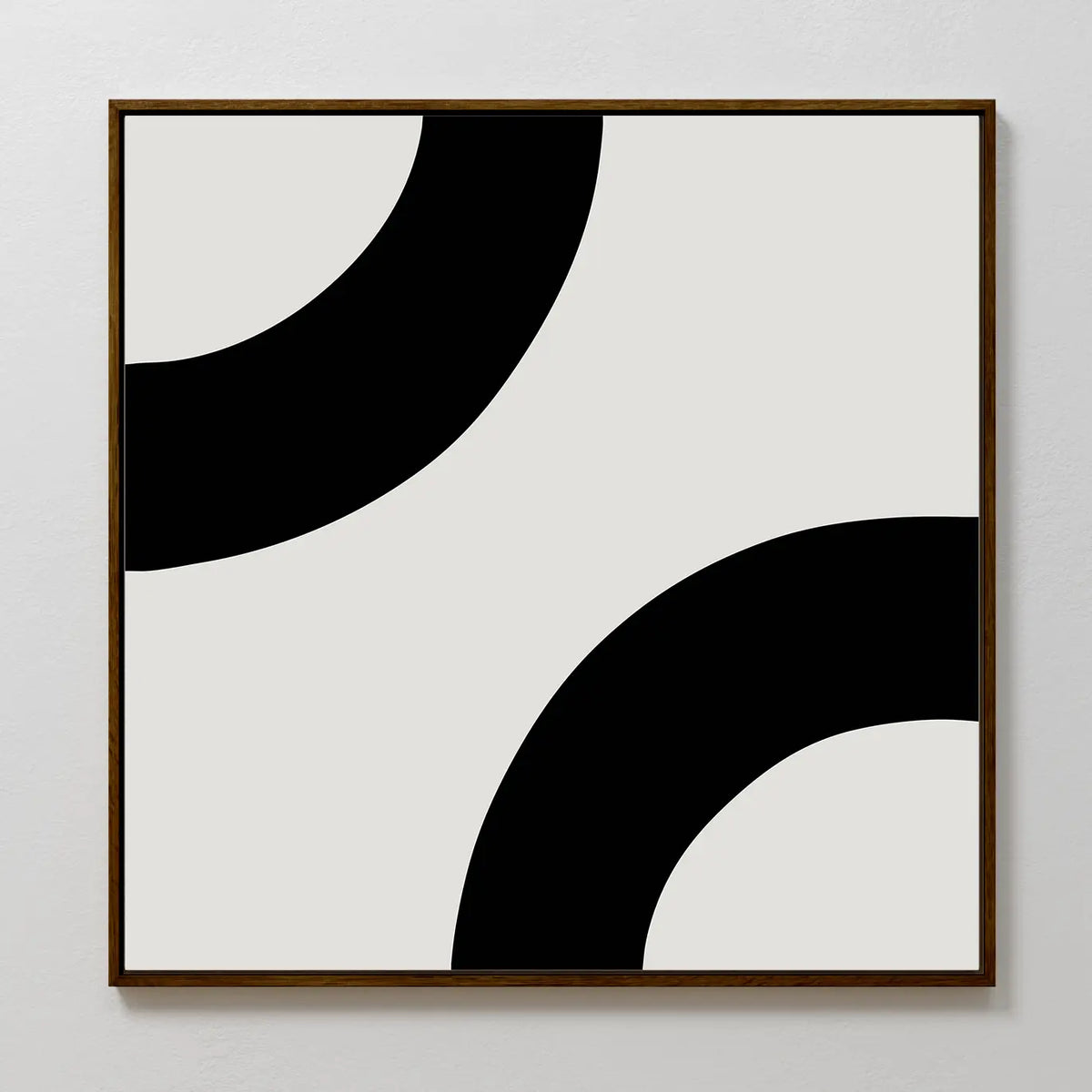 Bold Orbit Canvas Art is a minimalist square print featuring two thick black curves on light gray. Its bold, abstract design in a wooden frame makes it the perfect modern wall art for elevating contemporary interiors.