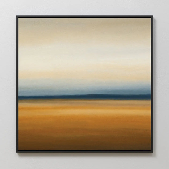 Caramel Plains Canvas Art showcases blended bands of warm golden brown with cool blue and soft gray, creating a tranquil abstract landscape. Perfect for modern bedroom decor, it comes framed in black and displayed on a white wall.