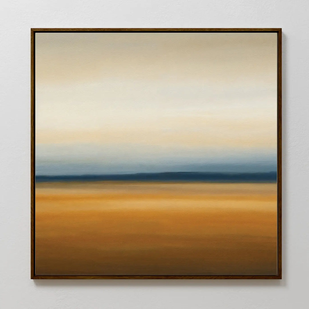 The Caramel Plains Canvas Art features horizontal bands of beige, blue, and golden brown for a serene landscape effect. Simply framed and ideal for modern bedroom decor, it looks stunning on a light-colored wall.