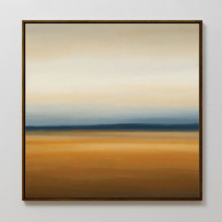 The Caramel Plains Canvas Art features horizontal bands of beige, blue, and golden brown for a serene landscape effect. Simply framed and ideal for modern bedroom decor, it looks stunning on a light-colored wall.