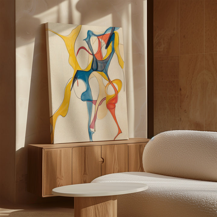 The Dance Of Unity Abstract Canvas Art, featuring flowing yellow, blue, and red shapes, sits on a wooden cabinet next to a white textured sofa and round table in a bright modern living room.