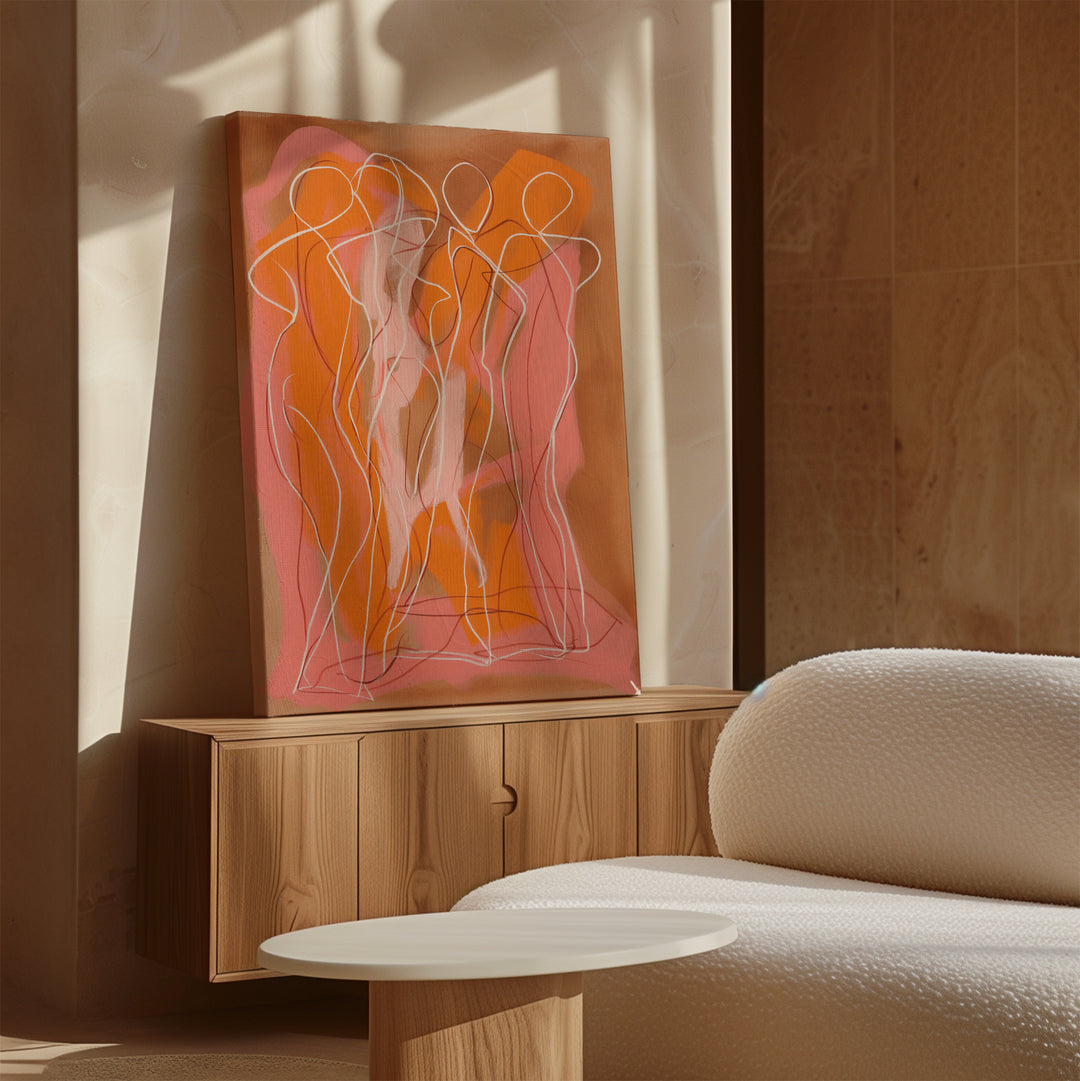 A modern living room showcases a wooden sideboard with the Dancing Silhouettes Abstract Canvas Art—outlined human figures in pink and orange—beside a white textured sofa and round coffee table, while sunlight casts soft shadows to elevate the decor.