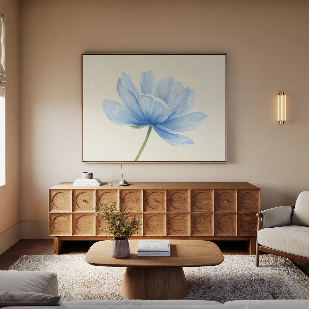 A modern living room with a light wood sideboard, a beige sofa, wooden coffee table with flowers, and the Daybreak Flower Canvas Art as minimalist wall decor above the sideboard, all illuminated by soft natural window light.