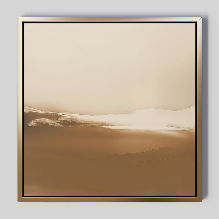 Desert Dusk Abstract Canvas Art features minimalist beige and brown tones with soft, blended layers that suggest a serene landscape, framed in simple gold and shown against a light gray wall.