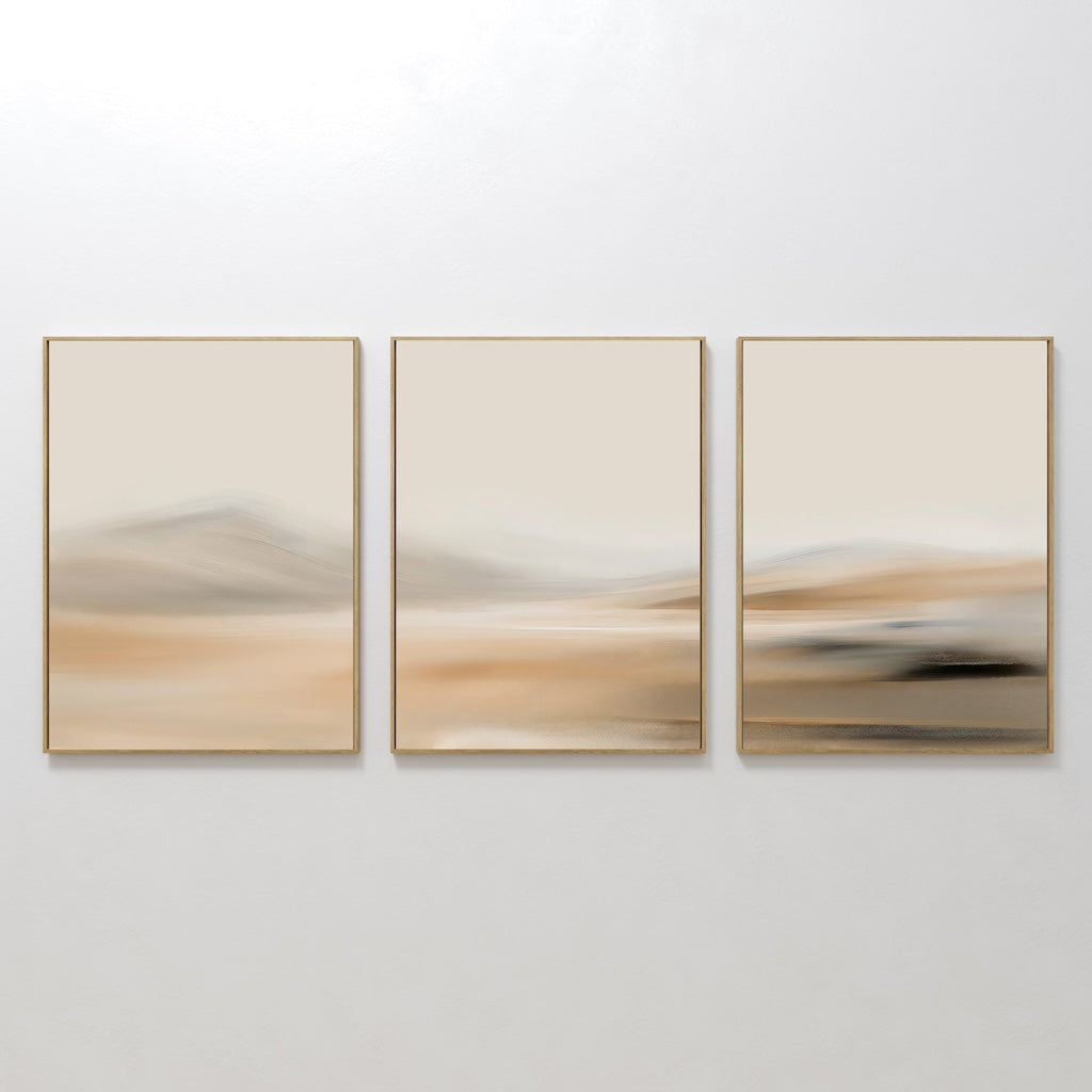 The Desert Haze Set of 3 features abstract wall art prints in gold frames with soft, blurred beige and tan tones, creating a minimalist landscape look—ideal for enhancing your living room decor.