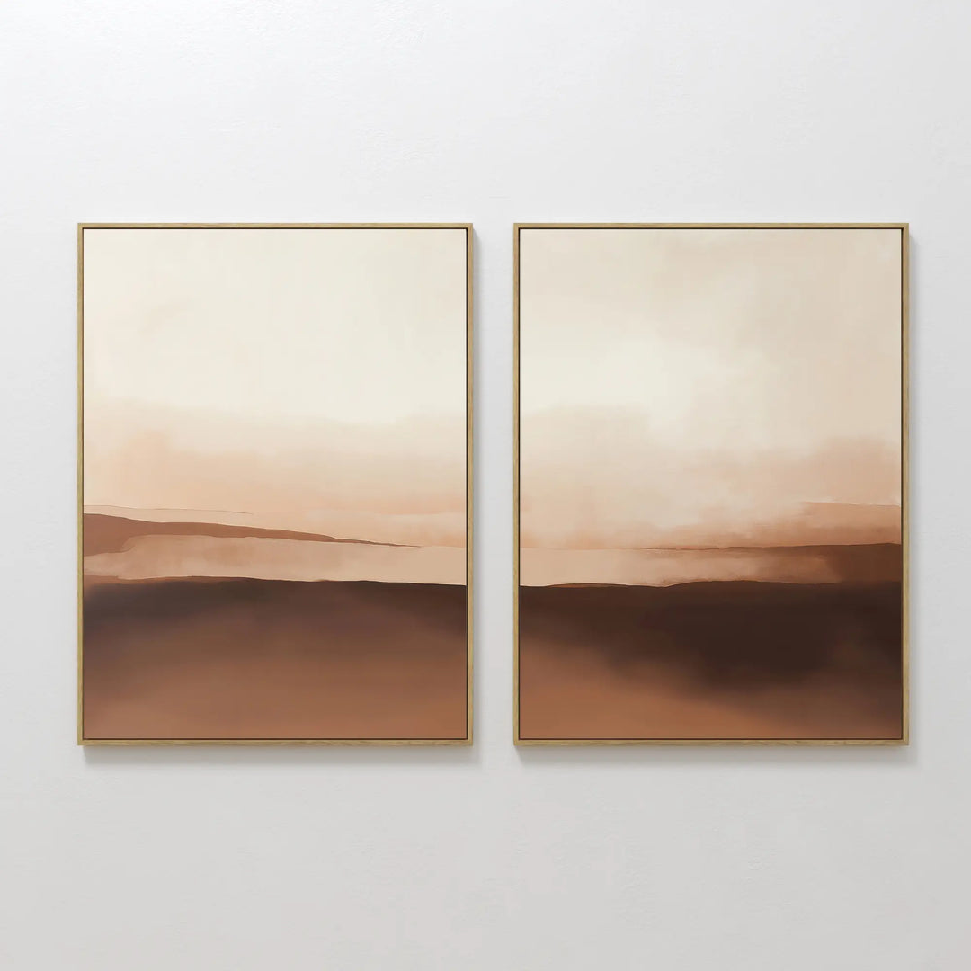 The Desert Landscape Set of 2 features abstract framed art in soft beige, brown, and cream tones, evoking serene desert vibes. Perfect for neutral interiors, hang them side by side on a white wall for a minimalist look.