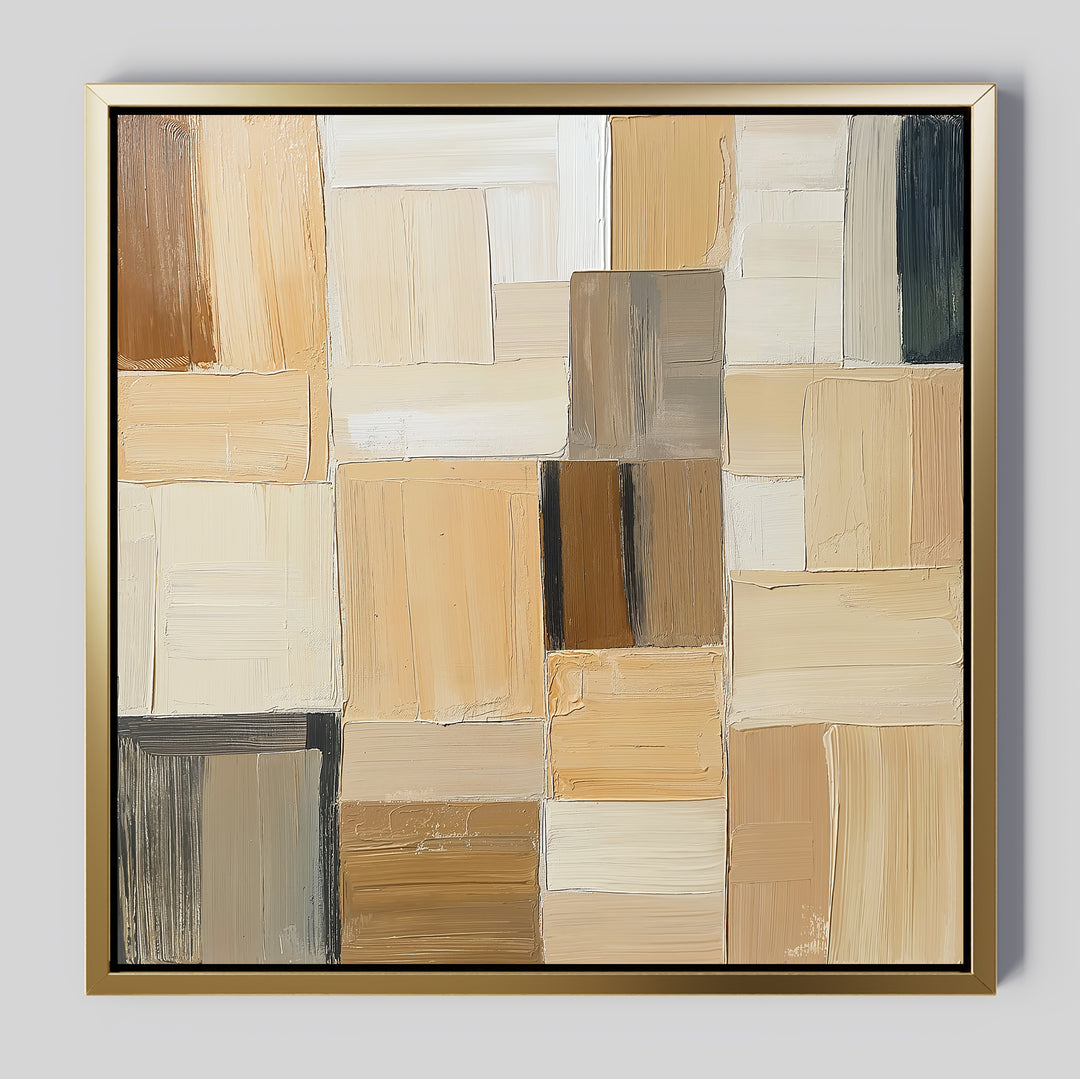 Desert Mosaic Abstract Canvas Art features overlapping rectangular blocks in beige, cream, tan, brown, and black. Visible brushstrokes add texture, while a thin gold frame completes this modern geometric wall decor.