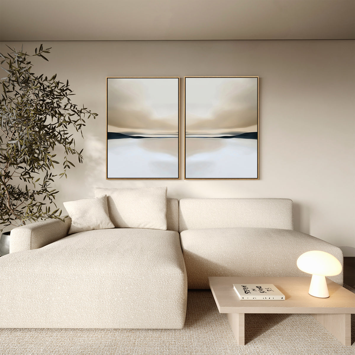 A modern living room featuring the Desert Quietude Set of 2 above a cream sectional, paired with a wooden coffee table and lush potted plant—perfect inspiration for stylish, contemporary living room decor.