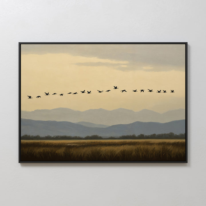 Distant Flight Canvas Art features a landscape with distant mountains, fields, and a V-shaped flock of birds soaring across a cloudy sky—an ideal addition to your wall art print collection.