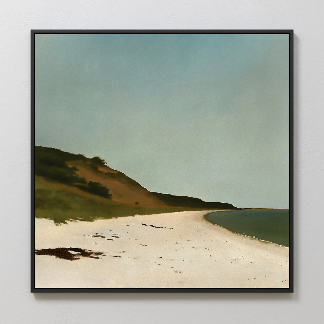 The Drift Shore Canvas Art, featuring a sandy beach, gentle waves, grassy dunes, and a clear blue sky, hangs beautifully on a white wall.