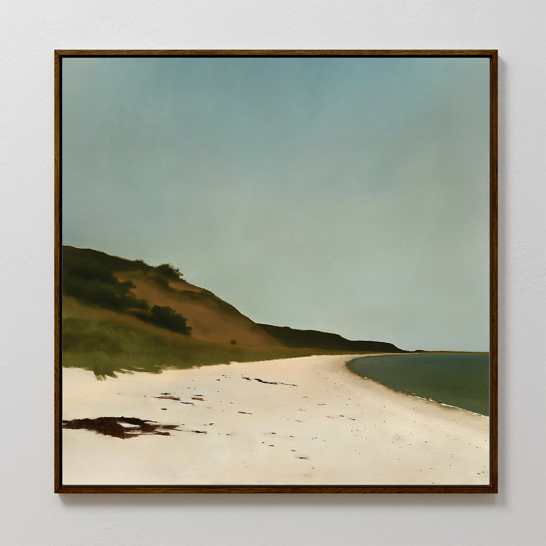 Drift Shore Canvas Art features a quiet beach with pale sand, grassy dunes, and a calm blue sky. This framed canvas is perfect minimalist wall art to bring tranquility to any space.