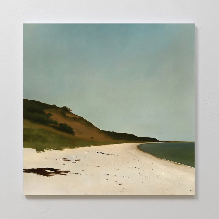 Drift Shore Canvas Art features a minimalist painting of a tranquil beach with white sand, seaweed, green hillside to the left, and calm blue water beneath a clear sky—perfect for adding calming style to your space.