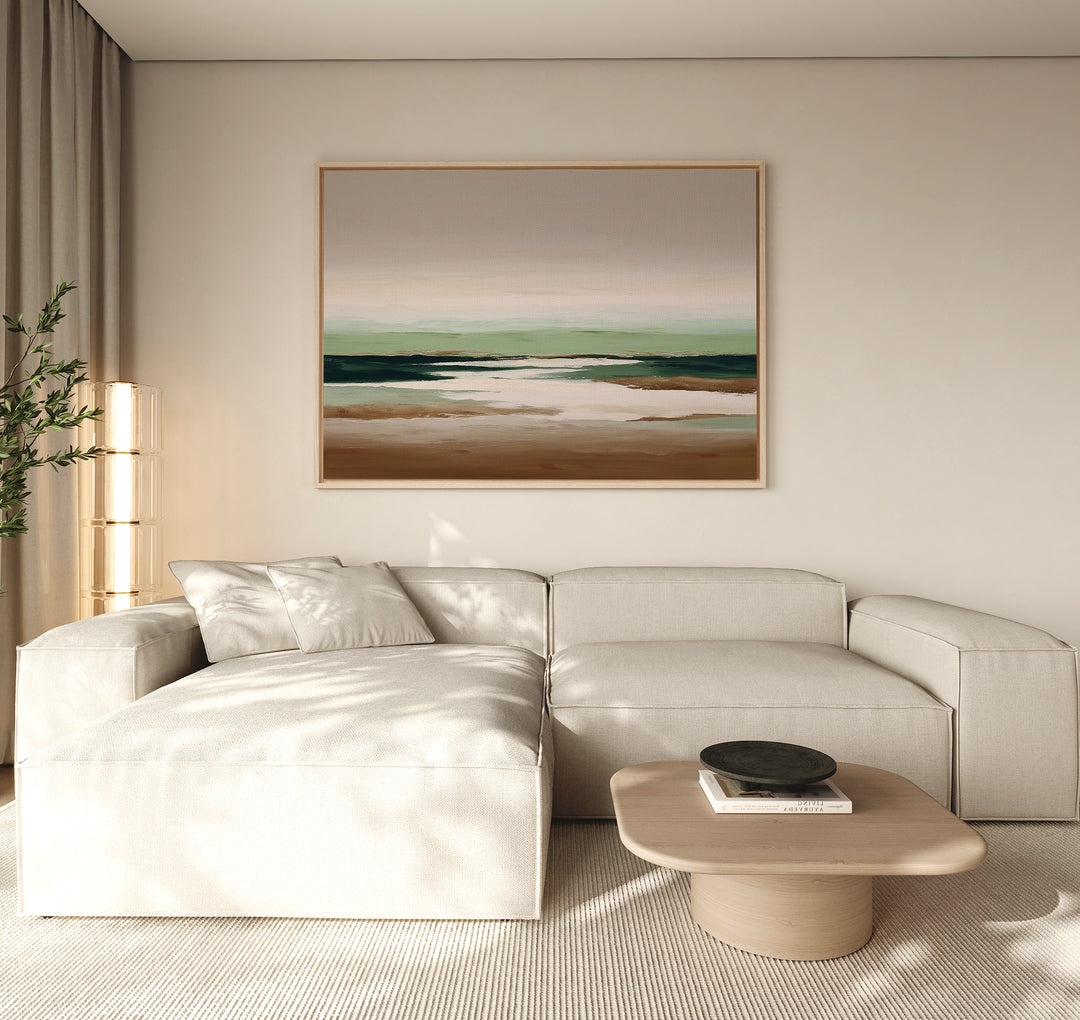Minimalist living room with a beige sectional sofa, light wood coffee table, and Earthbound Horizon Canvas Art on the wall. Neutral tones and natural light make the space calm and inviting.