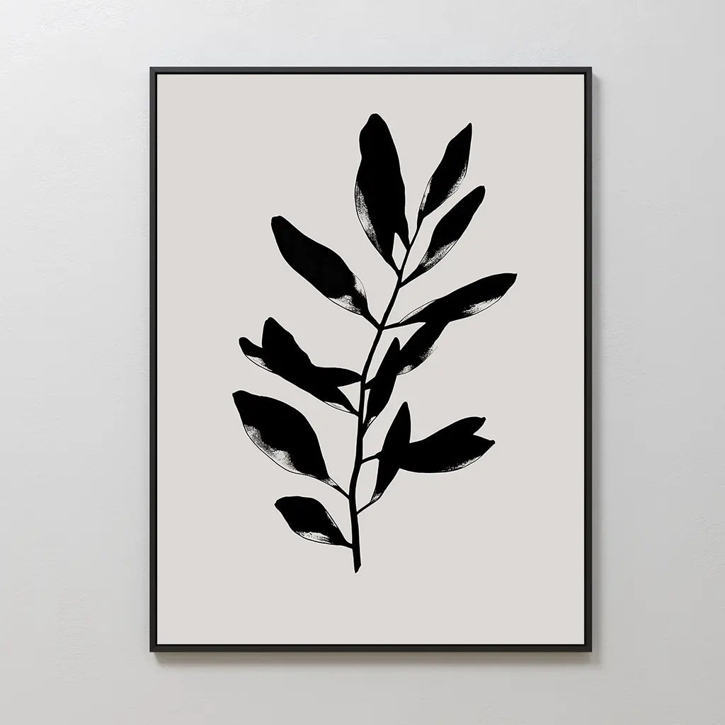 The Ebony Leaf Canvas Art features a minimalist black leafy branch with bold shapes on a light beige background. Framed in a thin black frame, it brings subtle elegance and modern style to any interior.
