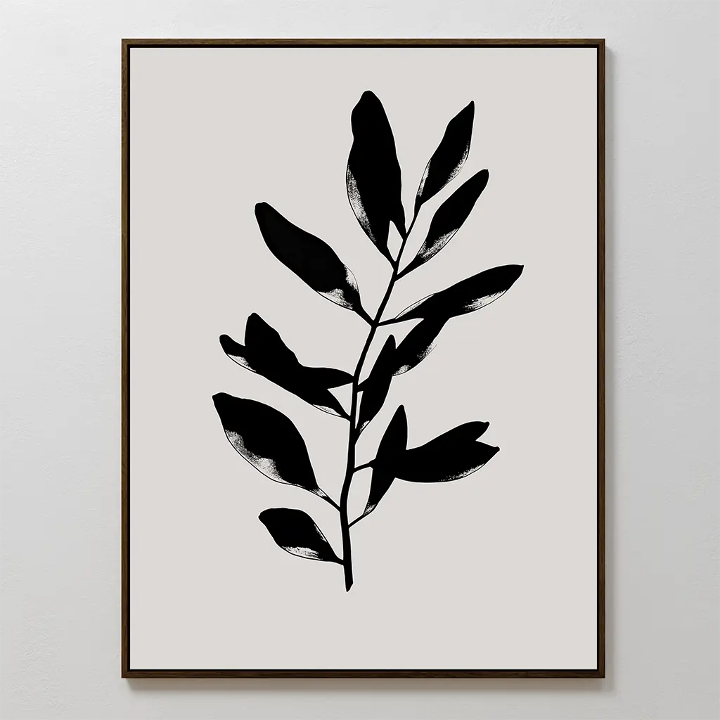 Ebony Leaf Canvas Art showcases a black leafy plant silhouette on a light beige background in a thin dark frame—perfect minimalist decor to add bold contrast and organic style to any modern interior.