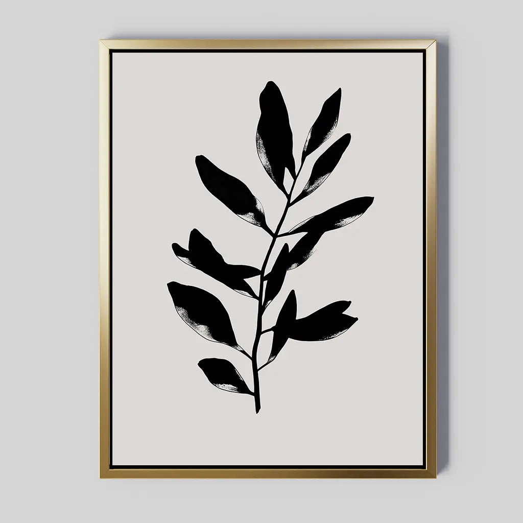 Ebony Leaf Canvas Art: a minimalist print with a black leafy branch silhouette, centered on light beige and framed in thin gold—ideal botanical wall art for modern interiors.
