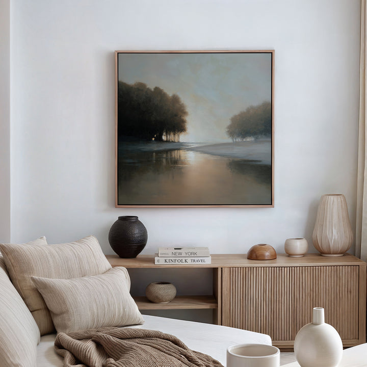 A cozy living room with beige and cream decor, a wooden sideboard adorned with vases and books, and the Ember Shore Canvas Art displayed above—perfect for elevating your living room style.