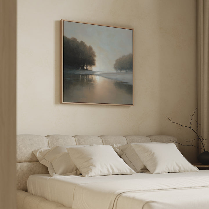 A serene bedroom features a beige upholstered bed with white bedding and pillows, accented by the Ember Shore Canvas Art above the headboard. Soft natural light enters from the side, creating a calm and inviting atmosphere.