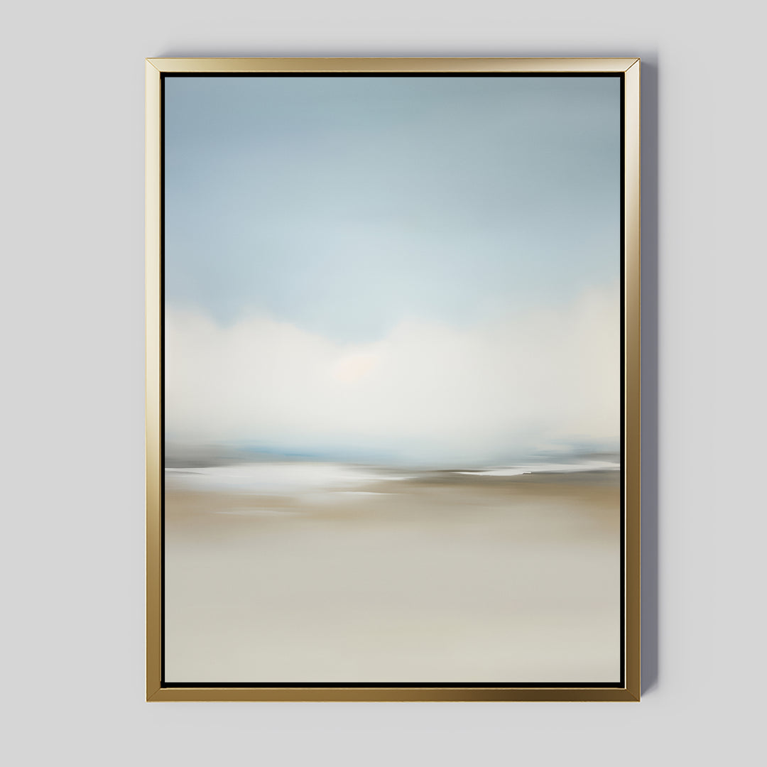 The Faded Silence Canvas Art is a framed abstract piece with soft, blurred blue, white, and beige tones in a minimalist design. This wall art features a gold frame and is displayed against a light gray wall.
