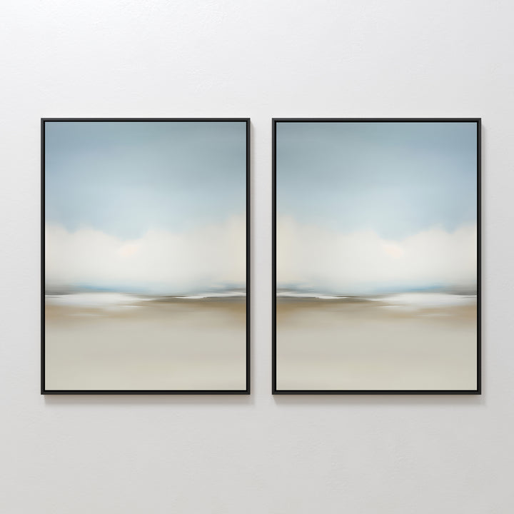 The Faded Silence Set of 2 features abstract wall art with soft, blurred beige, blue, and white tones. These framed pieces create a serene landscape look—ideal minimalist decor for modern spaces when hung side by side on a white wall.
