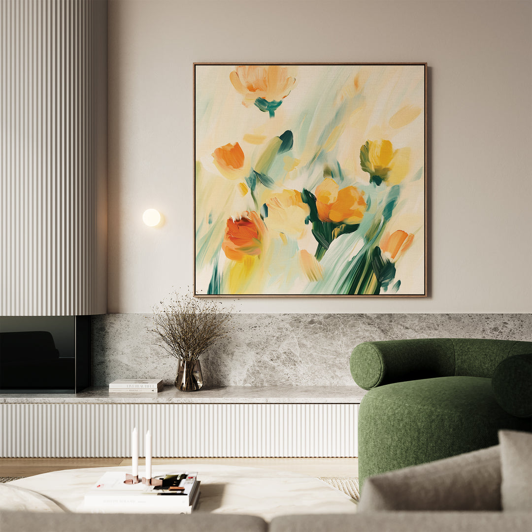 A modern living room with a green sofa, marble-topped console, and the Field Of Gold Canvas Art—an abstract floral painting in yellow and orange—hanging above dried flowers in a vase.