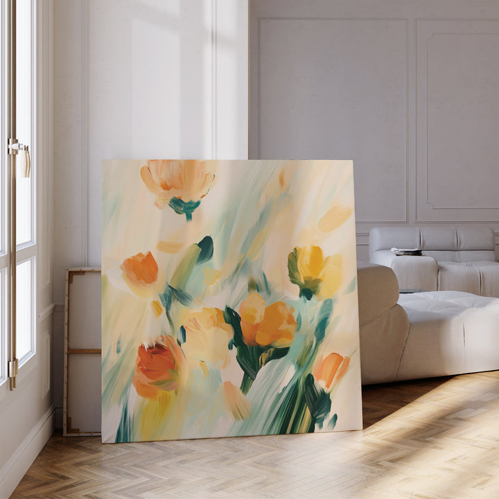 The Field Of Gold Canvas Art, featuring vibrant abstract orange, yellow, and green blooms, brightens a modern living room with wooden floors and white walls—perfect for stylish contemporary decor.