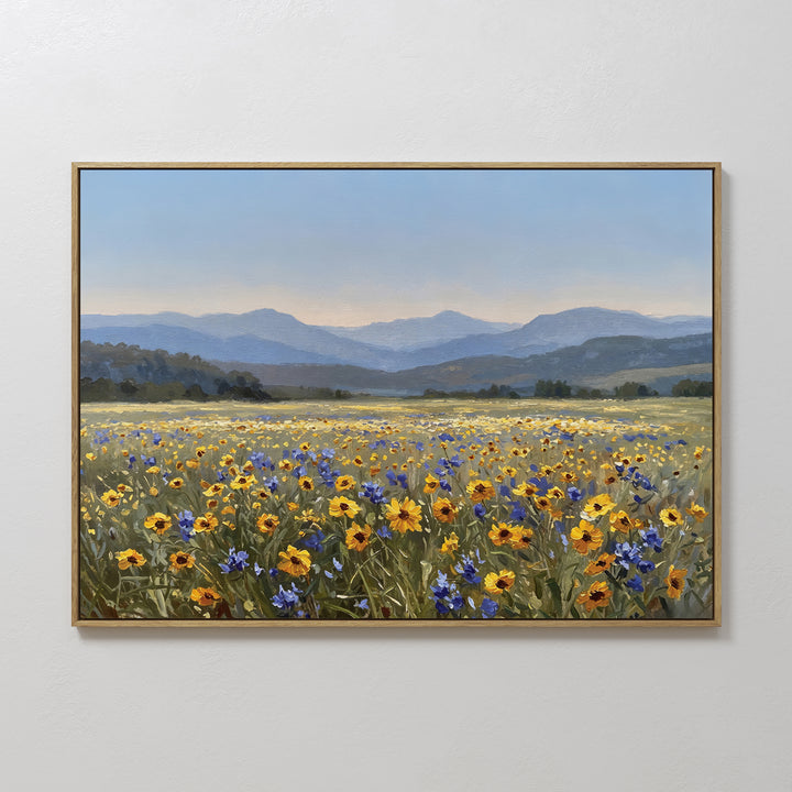 Add modern style to any space with the Fields of Color Canvas Art, featuring a vibrant field of yellow and purple wildflowers, distant green hills, and blue mountains beneath a clear sky. Framed for a stunning home decor accent.