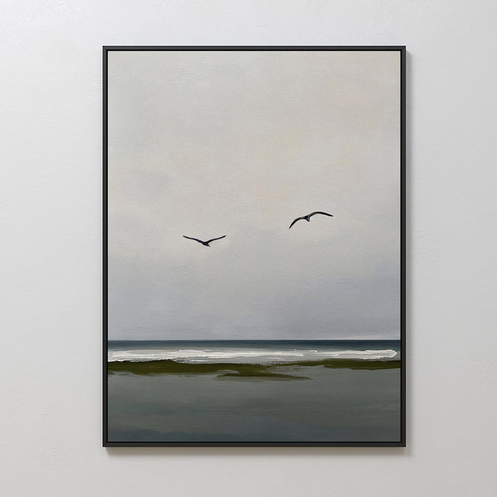 Freeflight Canvas Art is a framed painting of a calm seascape with two birds over gentle waves and a dark shore. Its minimalist, muted palette makes it perfect for adding tranquil decor to any space.