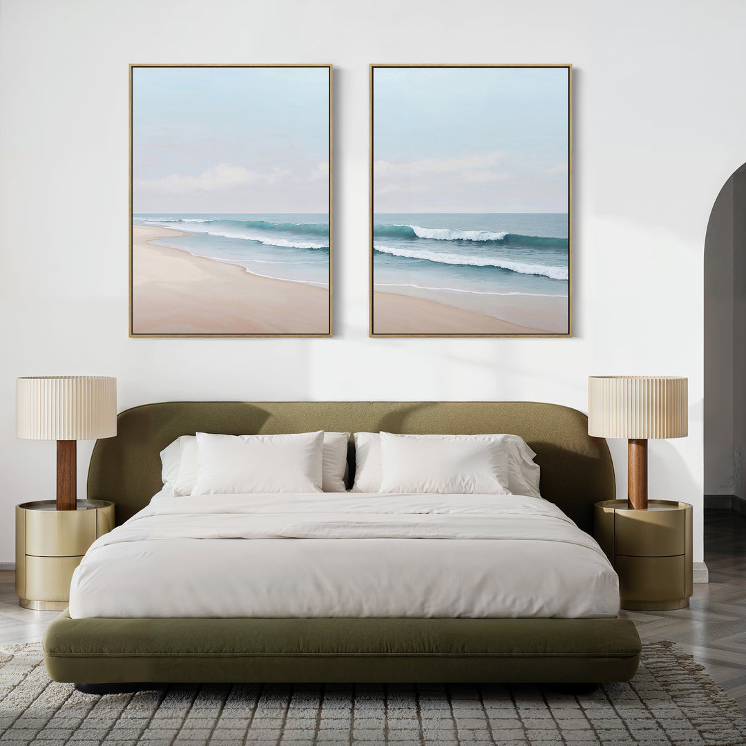 A modern bedroom features a green bed, white bedding, and gold nightstands with the Gentle Surf Set of 2 coastal wall art above the bed. Neutral decor and beach-inspired touches create a serene, minimalist space.