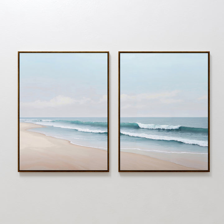 The Gentle Surf Set of 2 features two framed paintings—one depicting a sandy beach, the other gentle ocean waves under a light blue sky—creating calming coastal wall art perfect for living room decor.