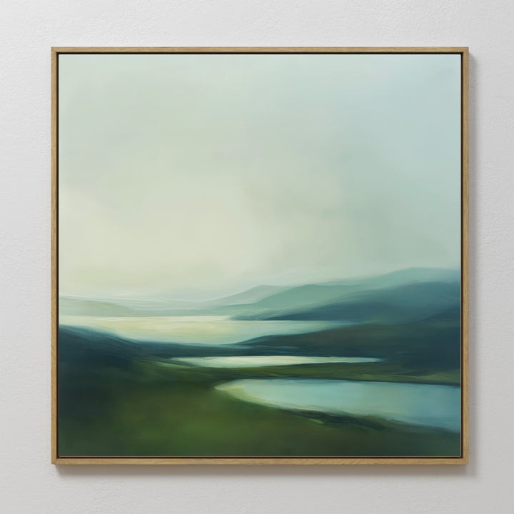 Gentle Valleys Abstract Canvas Art features soft green and blue hues with misty hills and rivers, creating a serene piece that adds calm to any living room decor.
