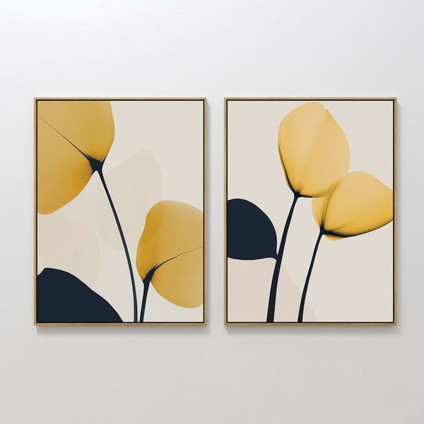 The Golden Leaves Set of 2 features framed minimalist wall art prints with abstract yellow and black floral shapes on a light background—perfect as large wall art for modern living room decor.