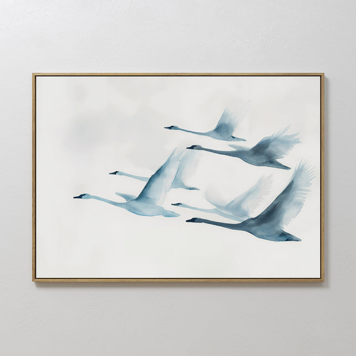 Graceful Flock Canvas Art showcases six blue-toned swans flying in formation on a white background, featuring soft watercolor brushstrokes—a stylish modern nature decor piece ideal for fans of Nordic wall art.