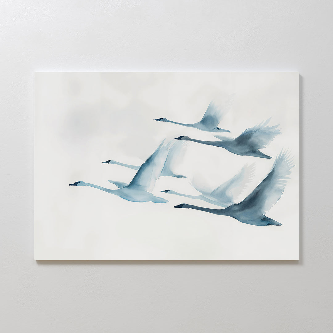 Graceful Flock Canvas Art features a minimalist watercolor of six swans in flight, painted in soft blue and gray on a light background—ideal for modern nature decor or as elegant Nordic wall art.
